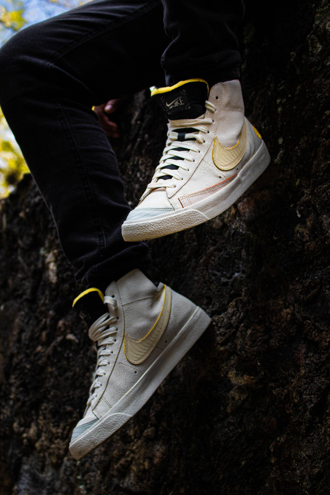 White Nike sneakers resting on natural stone, an icon of the brand's pre-owned resale appeal