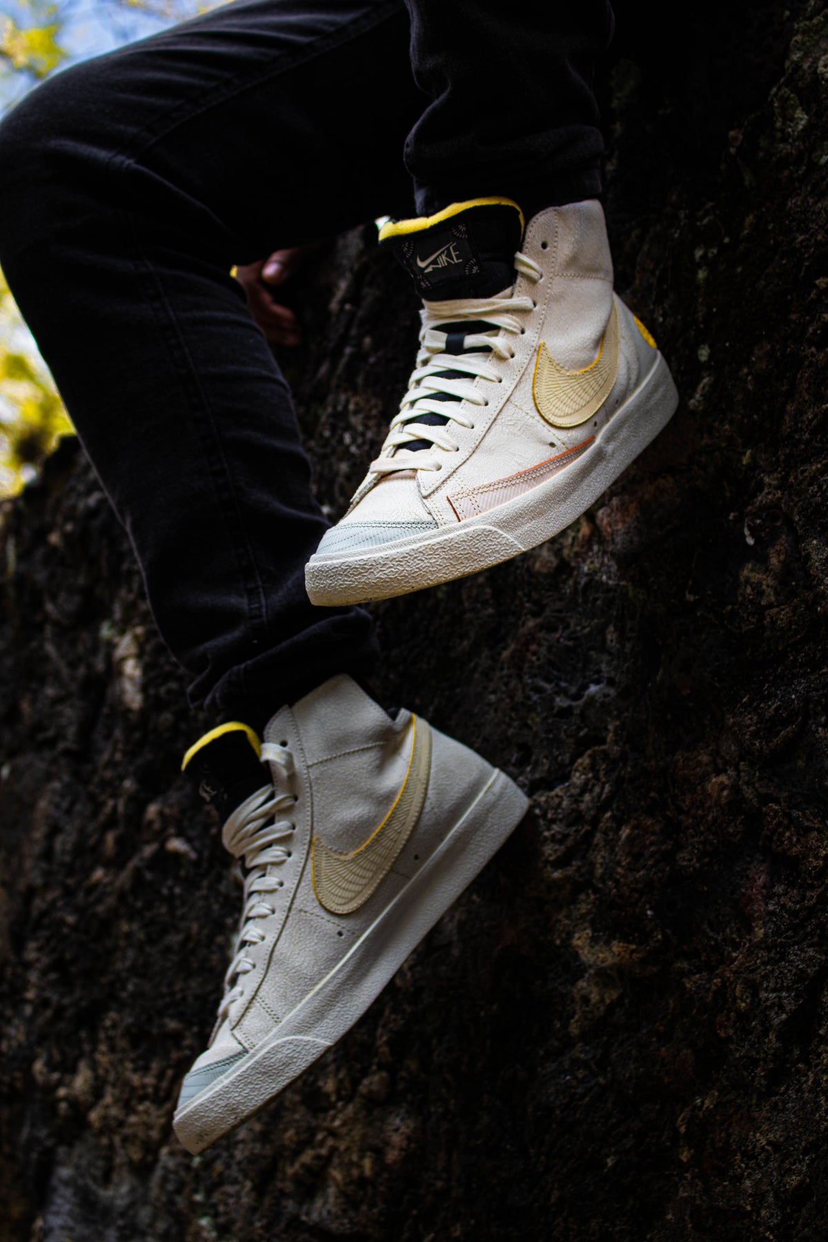 White Nike sneakers resting on natural stone, an icon of the brand's pre-owned resale appeal