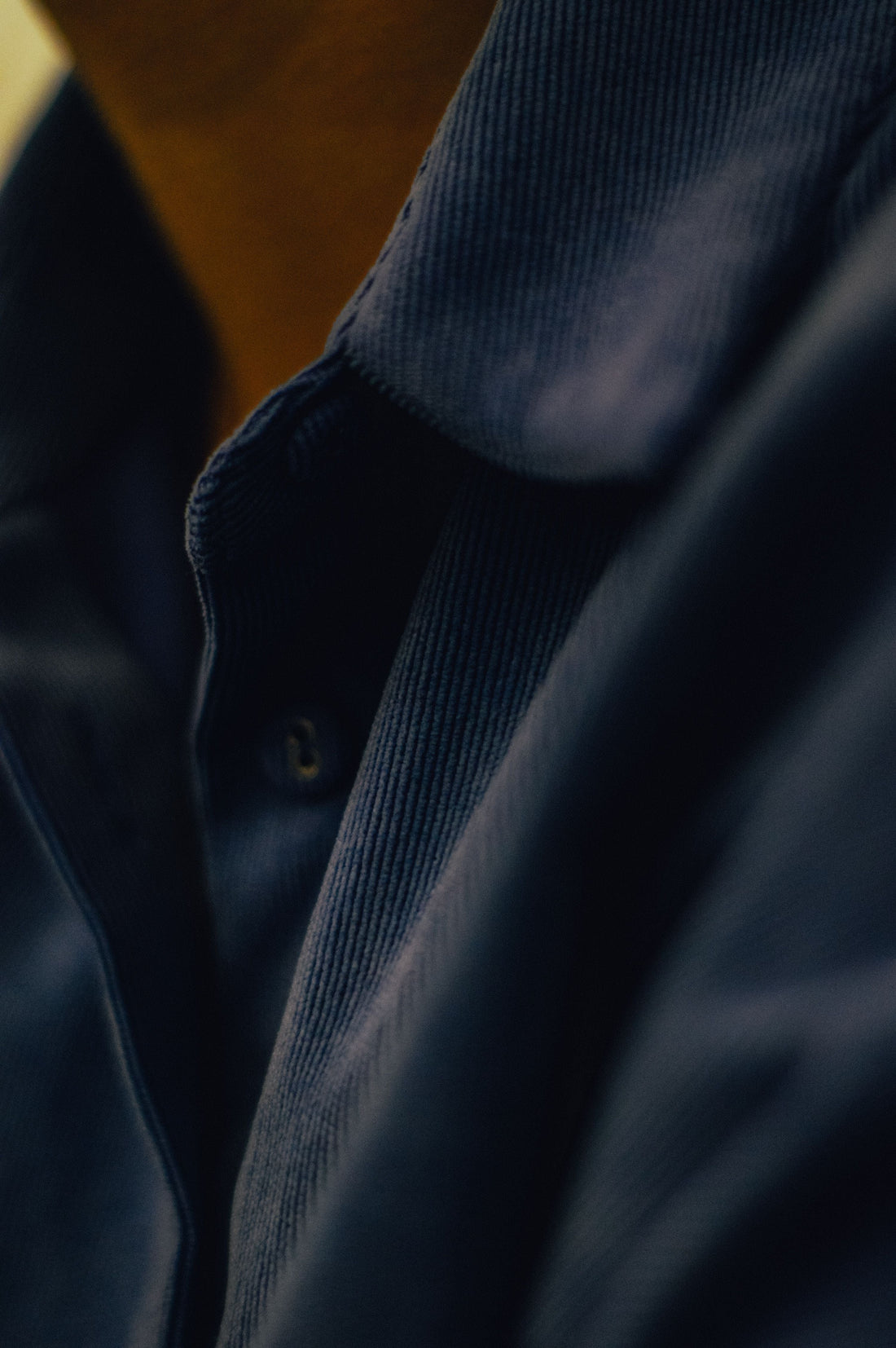 Close-up of a blue corduroy button-up shirt showing its ribbed texture, for CENT'ANNII's pre-owned corduroy care guide