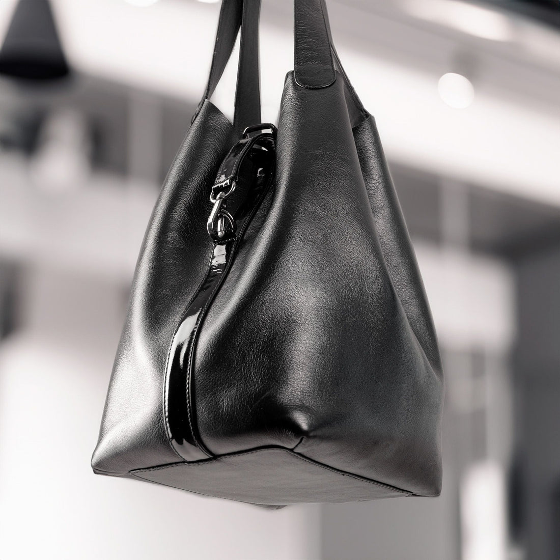 Close-up of a designer leather handbag showing hardware and stitching detail