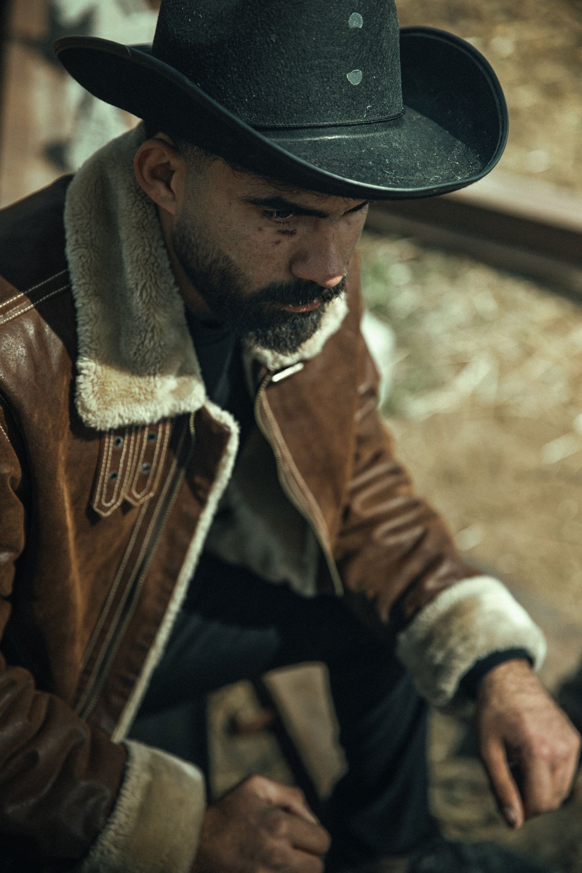 Weathered vintage shearling jacket with shearling collar worn outdoors in natural daylight, representing the pre-owned shearling pieces covered in CENT'ANNII's care guide