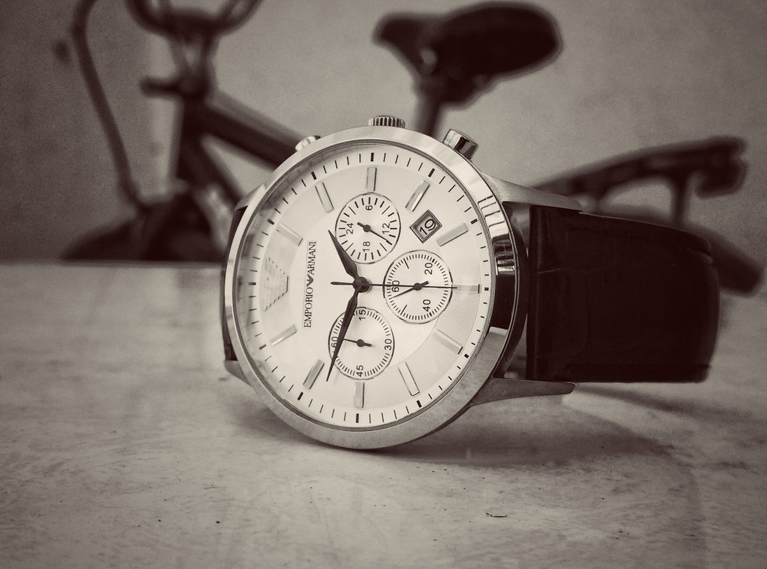 Close-up of a classic stainless steel wristwatch with a black leather strap